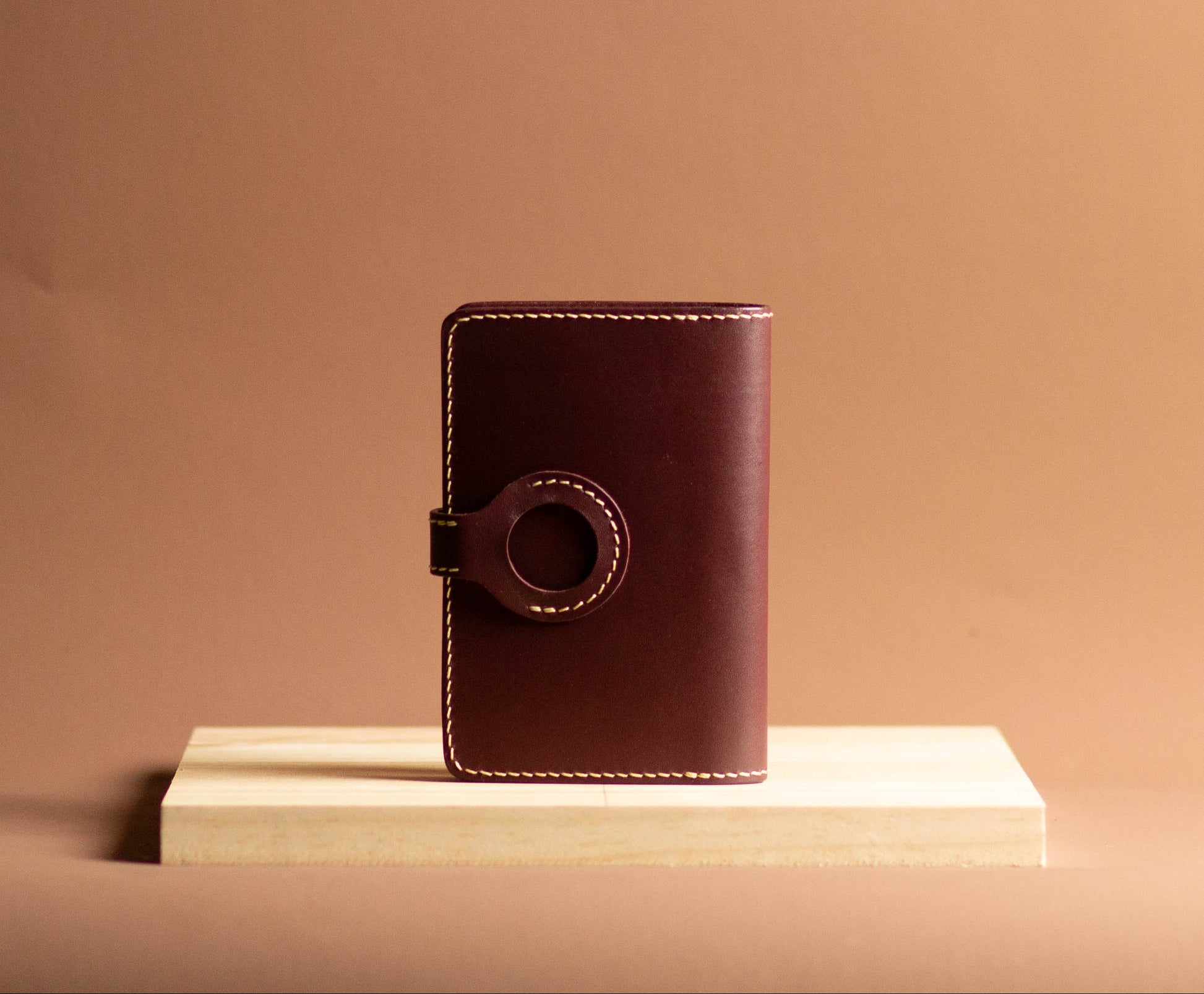 Brown leather notebook on a beige surface with a beige background